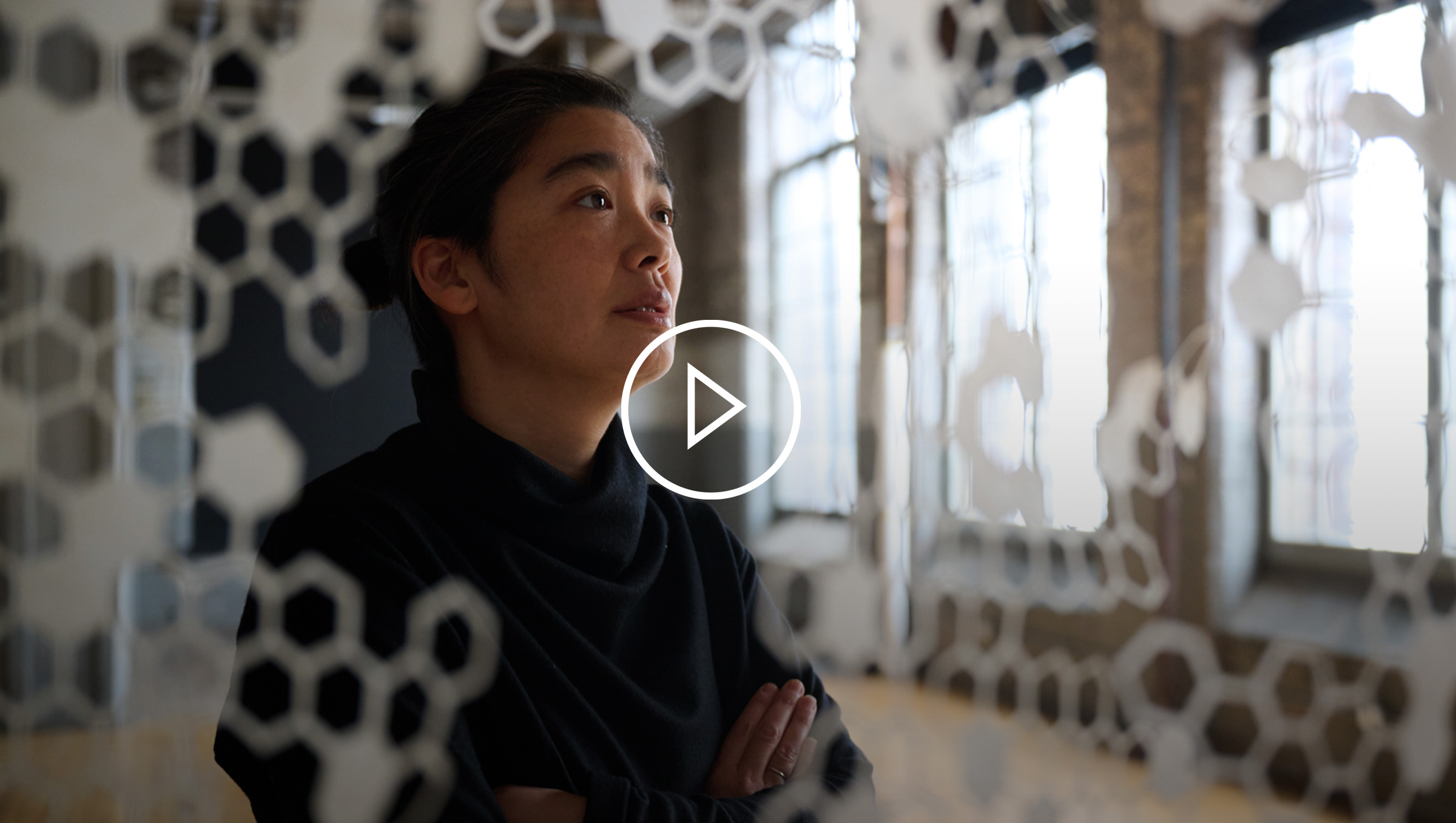 Canadian artist Hitoko Okada admiring her hanging art