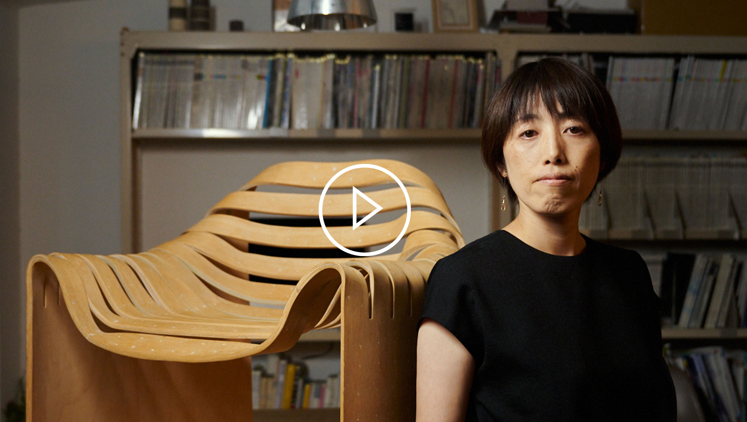 Close-up shot of architect Yuri Naruse sitting on wooden furniture