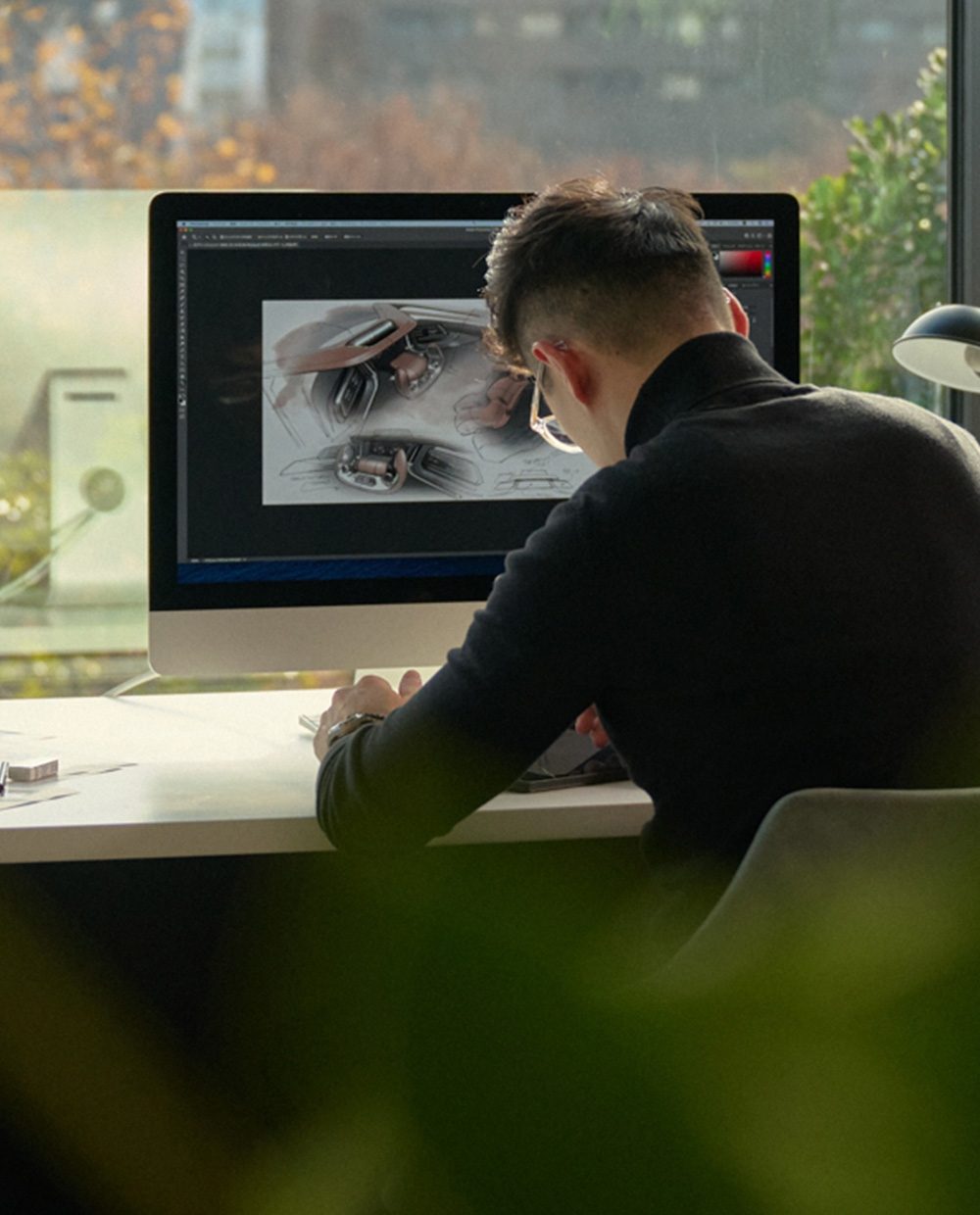 Tom Hu drawing cars and designing the 2025 INFINITI QX80 SUV