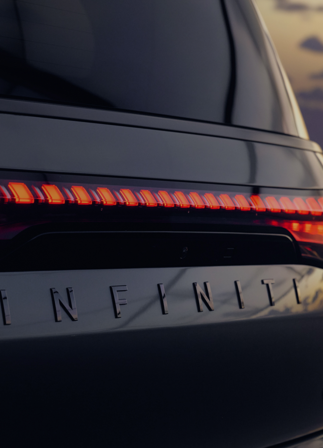2026 INFINITI QX80 Makers Series video thumbnail showing illuminated rear taillights