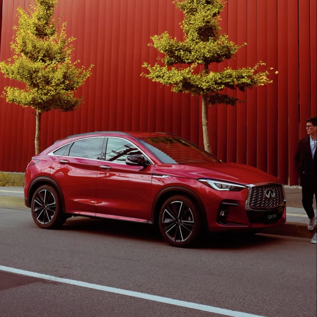 A red INFINITI QX55 5-seater crossover coupe