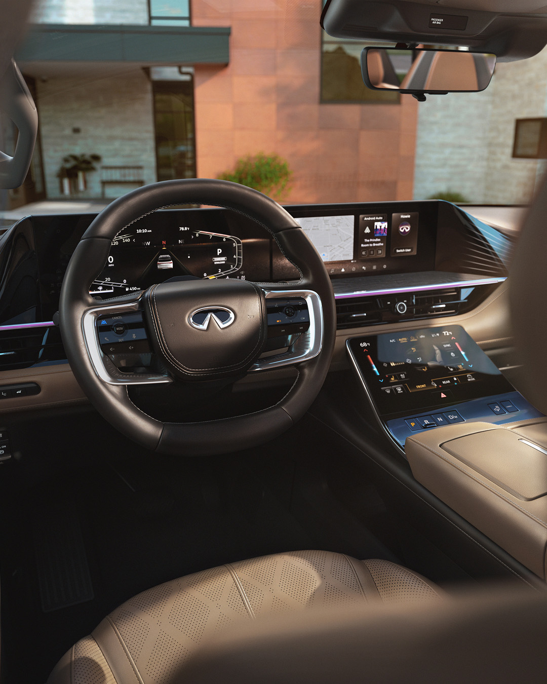 INFINITI vehicle interior cockpit view showing digital instrument cluster, touchscreen, and IQ Technologies interface