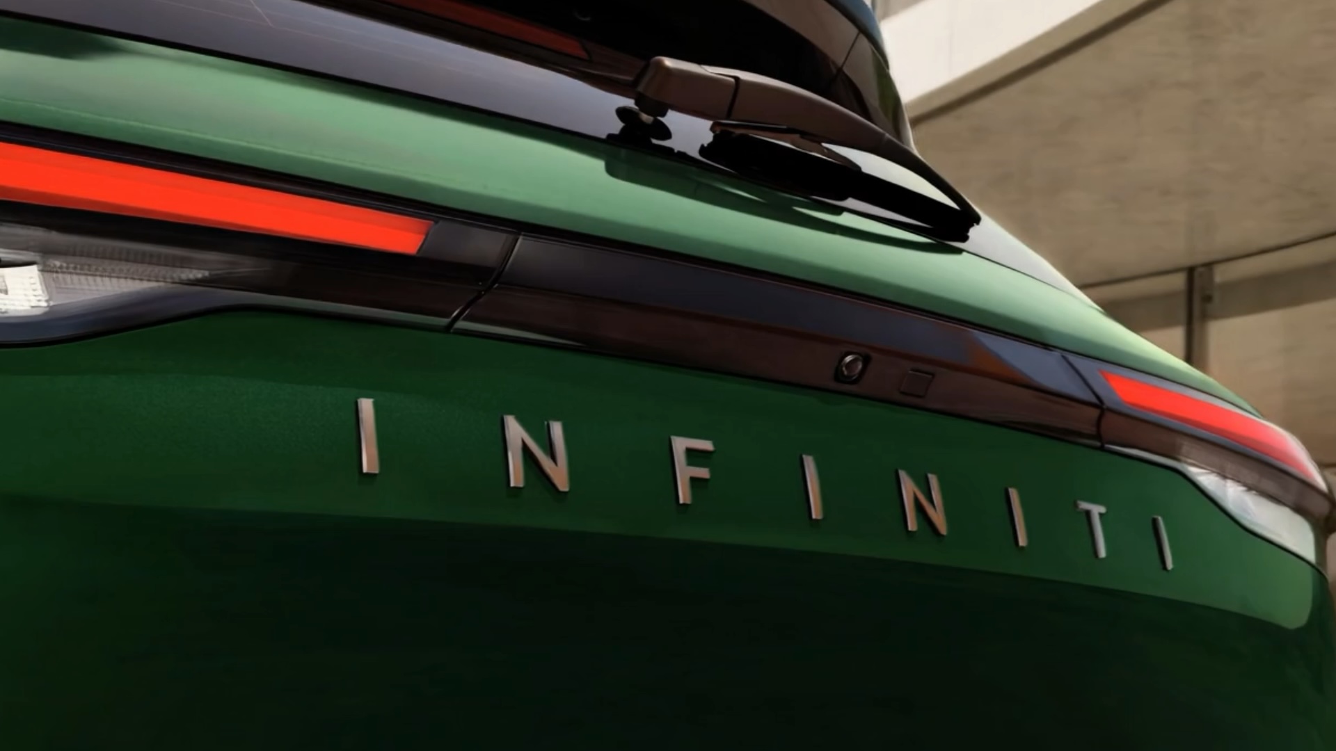 Rear view of new INFINITI QX60 showcasing bold taillight styling and INFINITI emblem