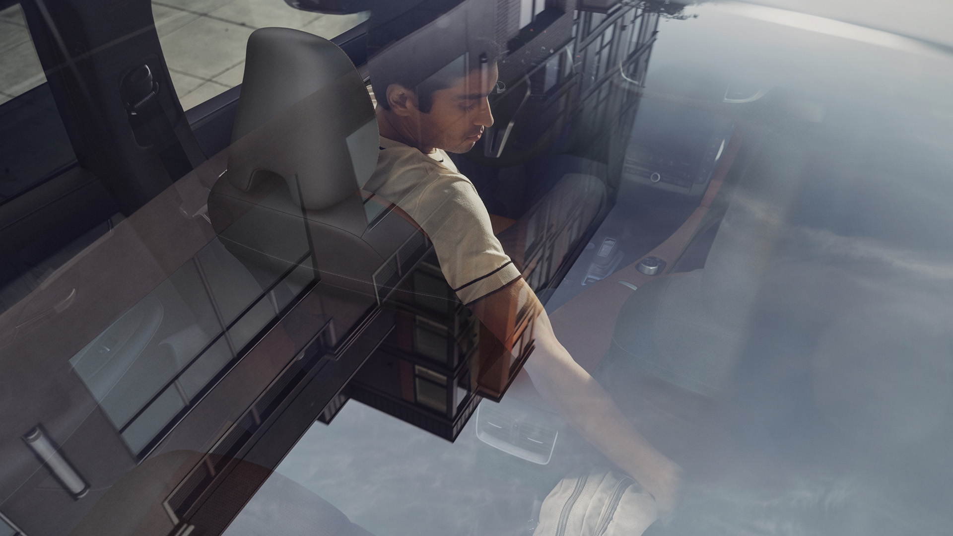 Interior cabin of 2025 INFINITI QX50 with dual-zone climate control showing driver in comfortable front seat