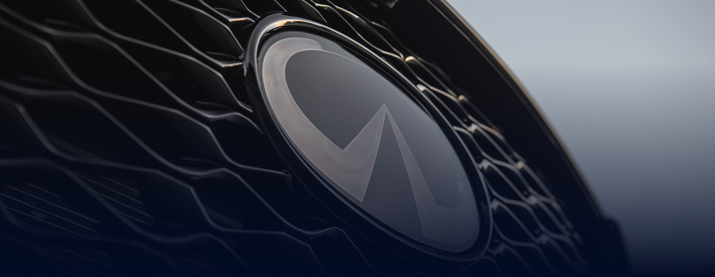 INFINITI QX60 grille in close-up with dark background