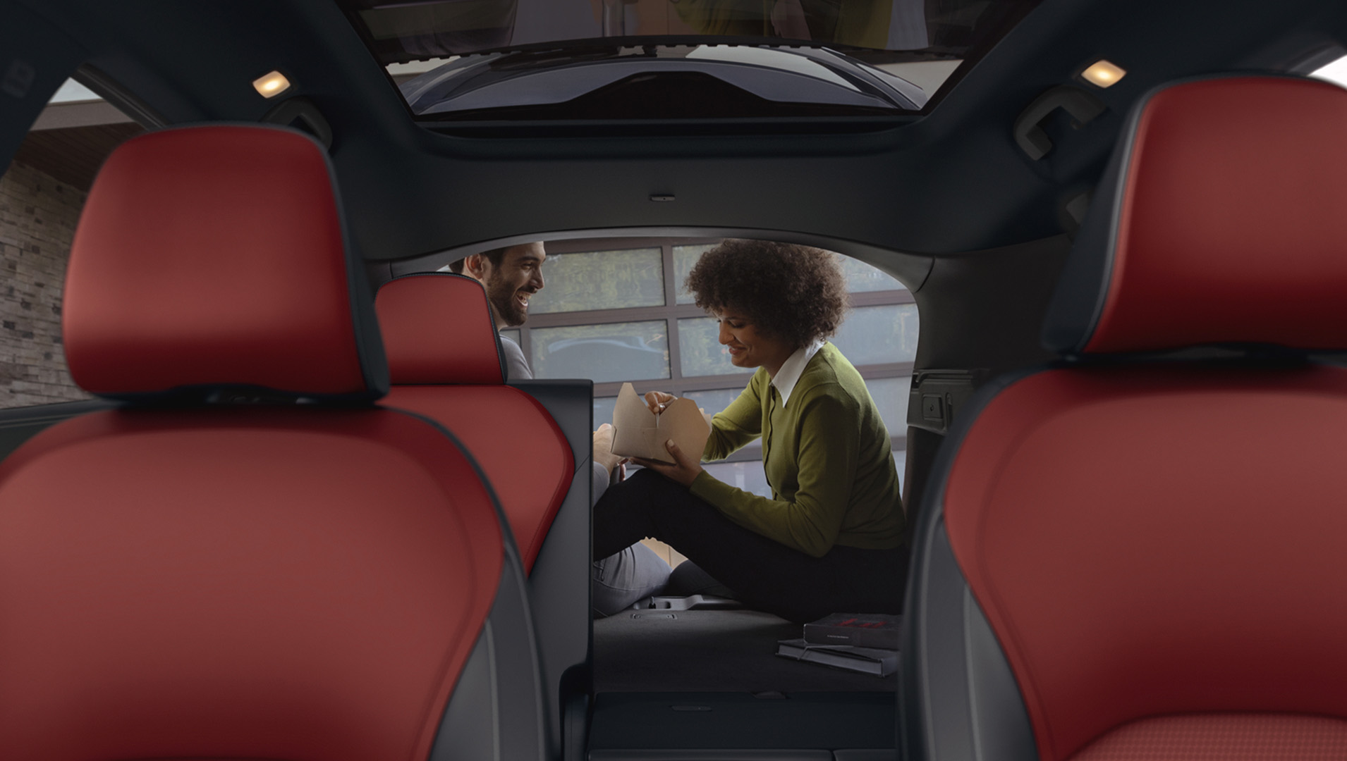 Interior rear view of 2025 INFINITI QX50 showing red leather seats and cabin space for five passengers