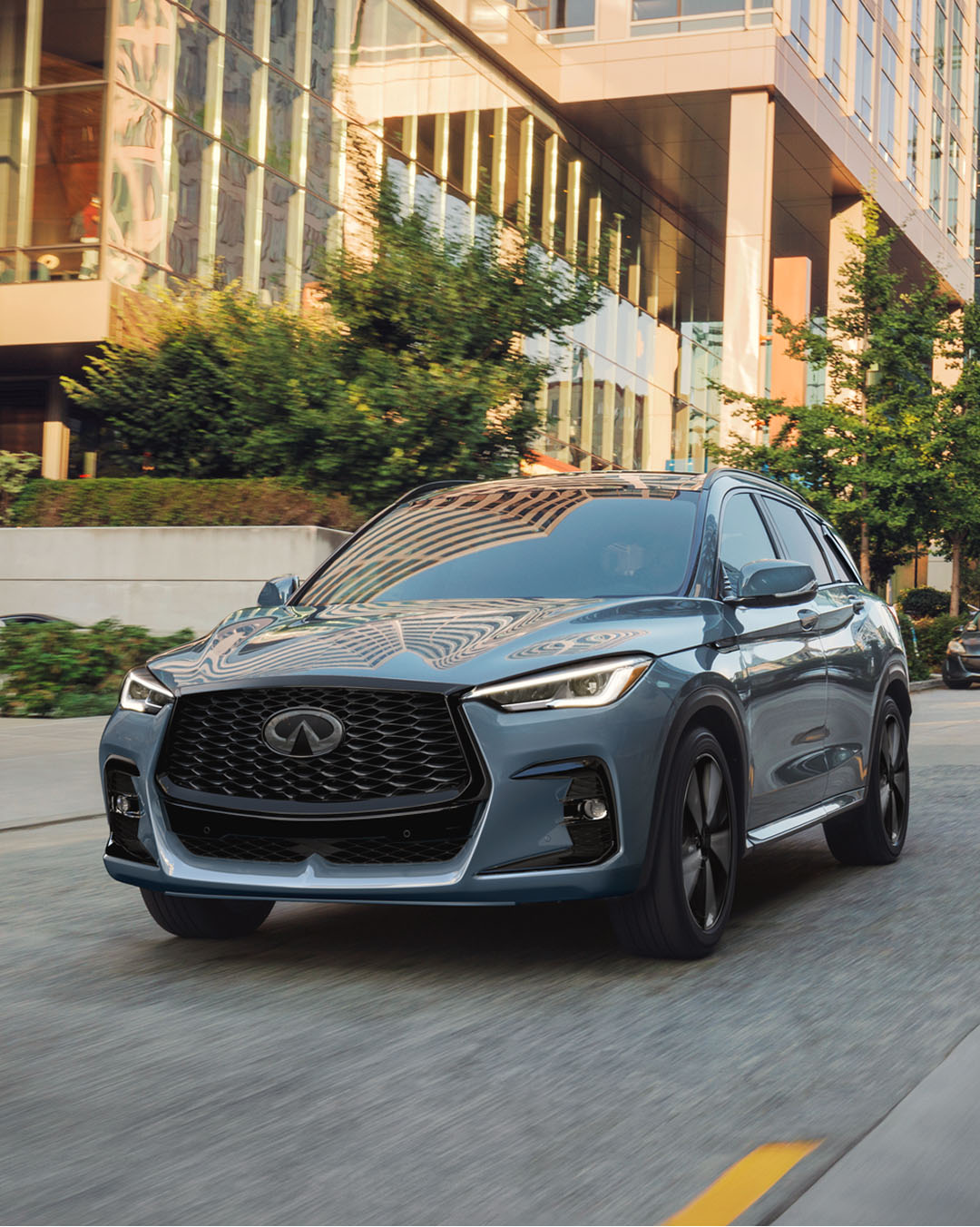 2025 INFINITI QX50 exterior in motion highlighting sculpted hood and dynamic proportions