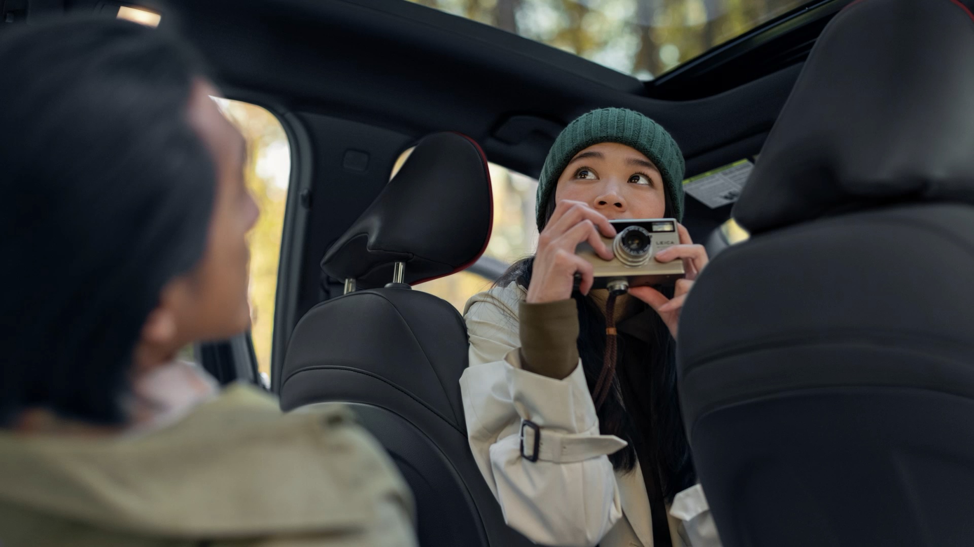 INFINITI QX50 passenger pointing camera through moonroof