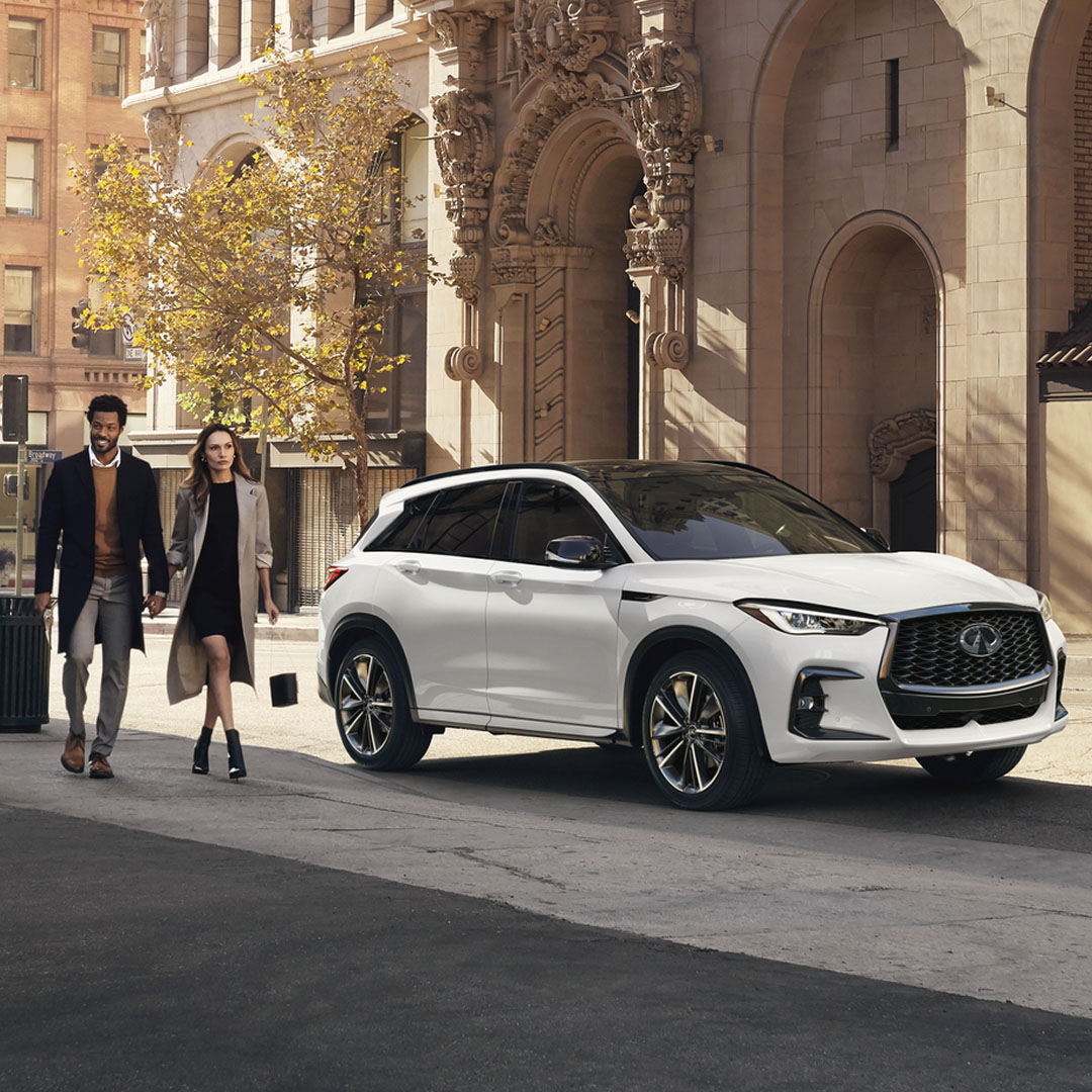 2025 INFINITI QX50 exterior design image featuring city setting and head-turning white crossover