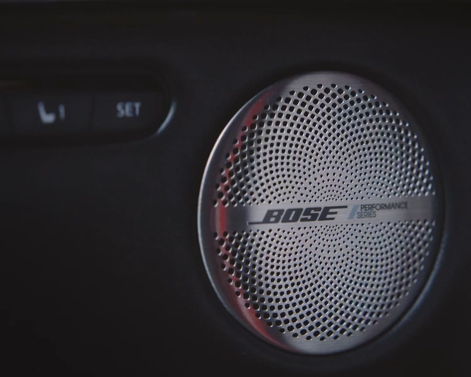 Close-up of Bose Performance Series speaker in the QX55 with metallic grille