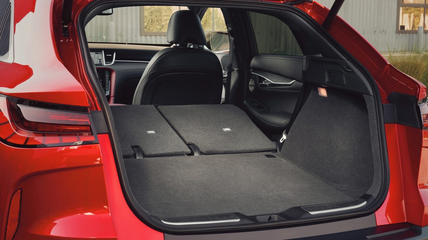 QX55 cargo area with seats down to show expandable luggage capacity