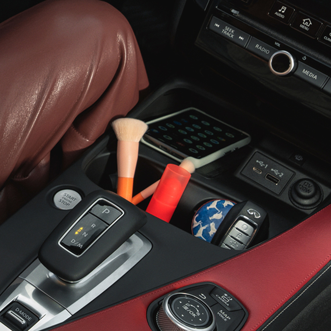 Center console with USB ports and wireless charging mat in the QX55