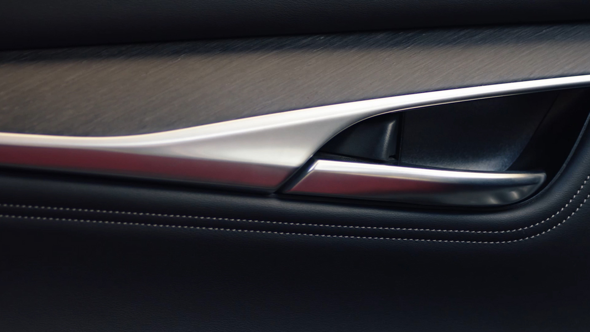 QX55 door panel featuring luxe materials and open pore wood trim