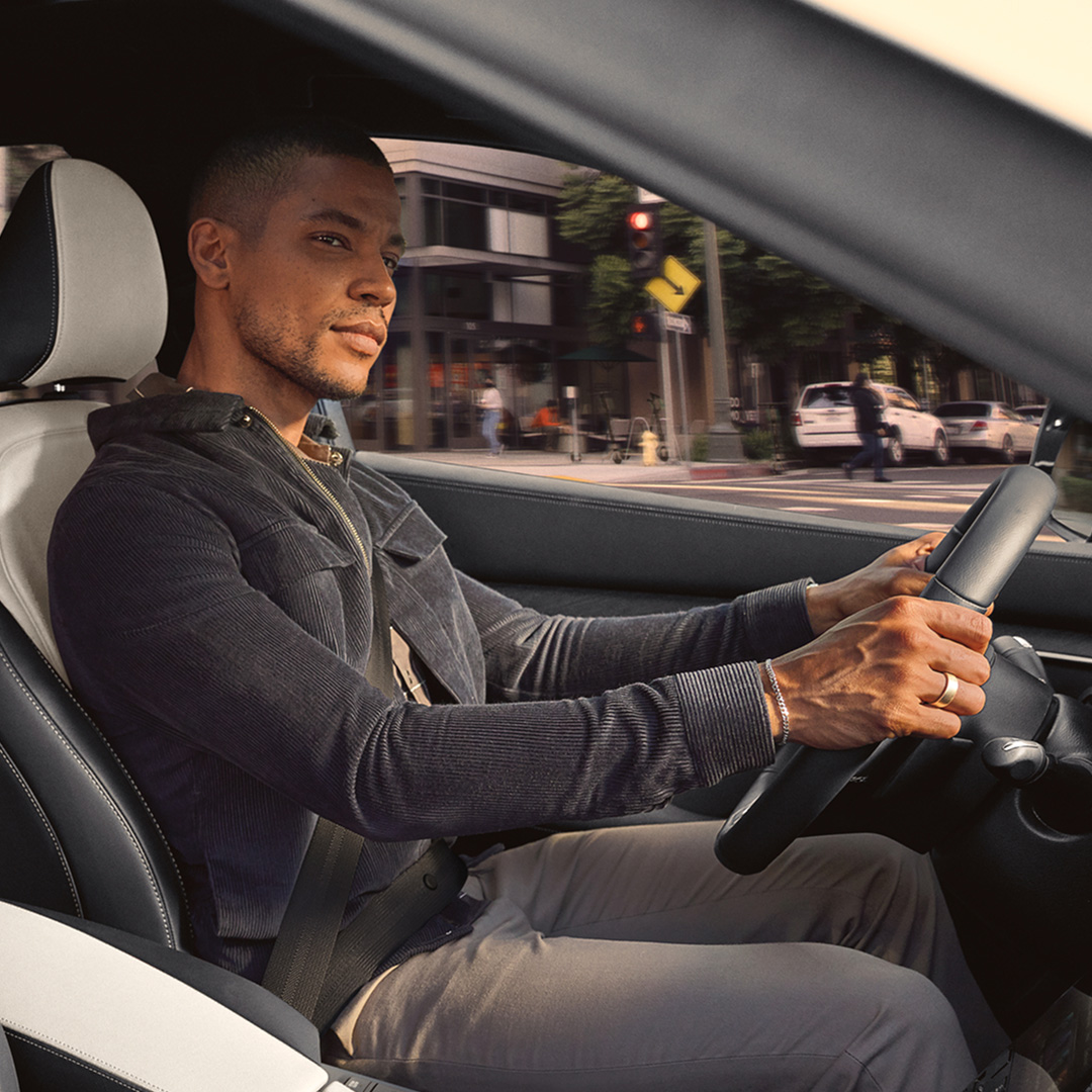 Driver enjoying a quiet ride with noise cancellation in the QX55