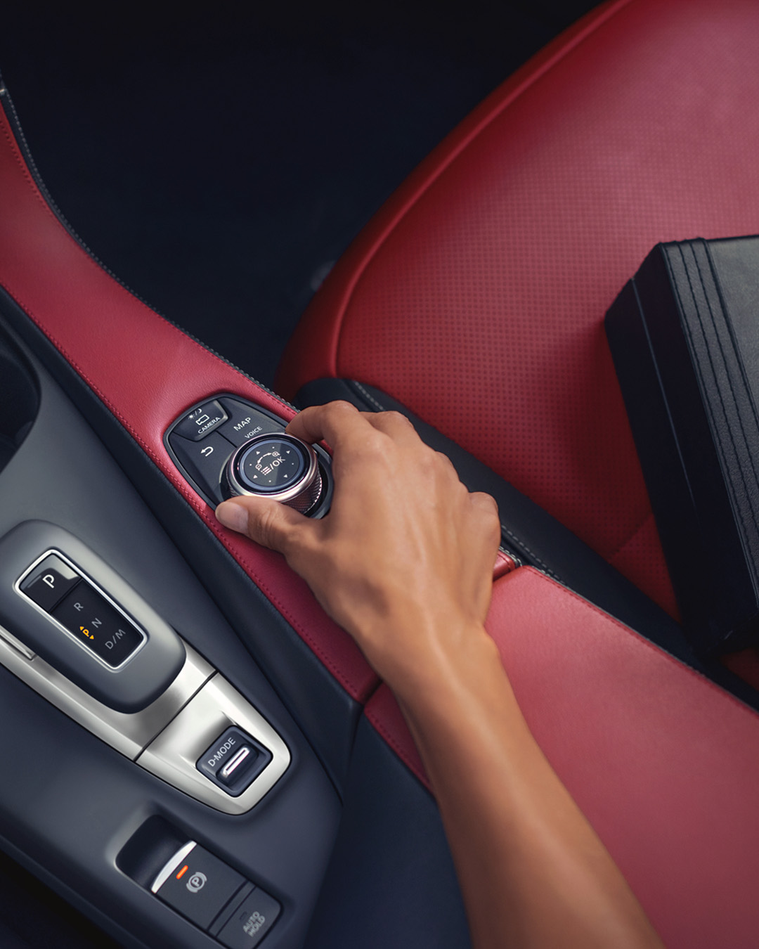 Driver rotating INFINITI drive mode selector