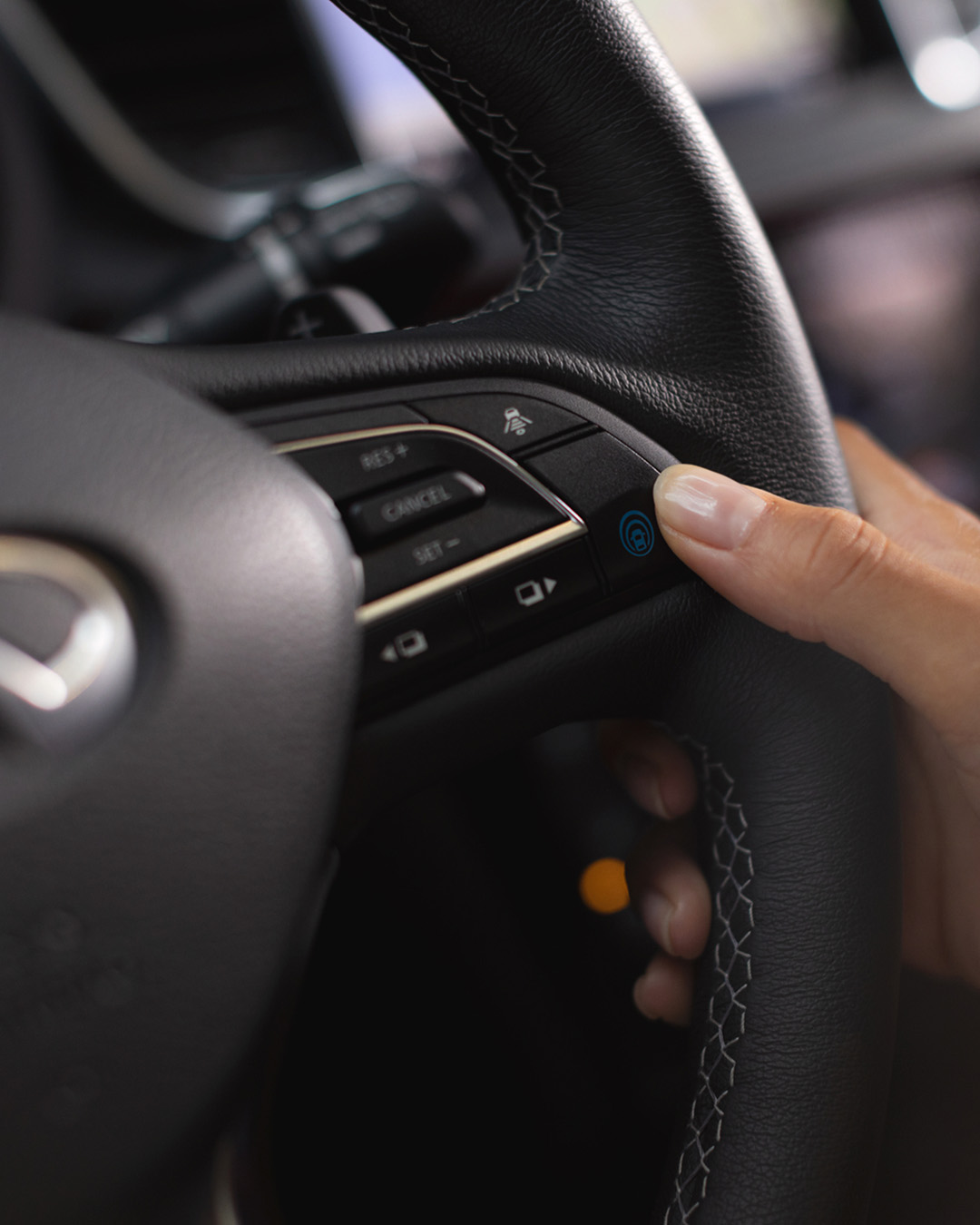 Close-up of steering wheel controls in QX55