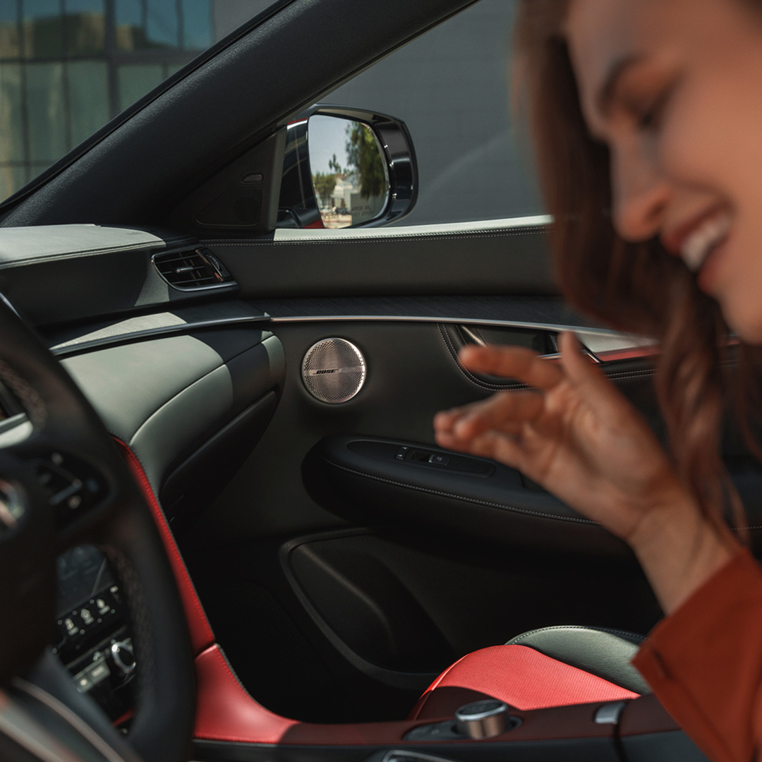 Woman enjoying red leather interior of 2025 INFINITI QX55