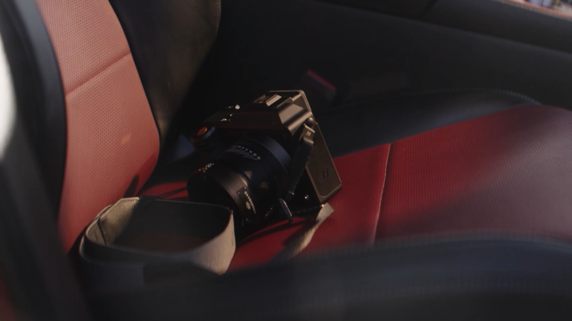 Red seat details and camera on the seat in the INFINITI QX55 interior