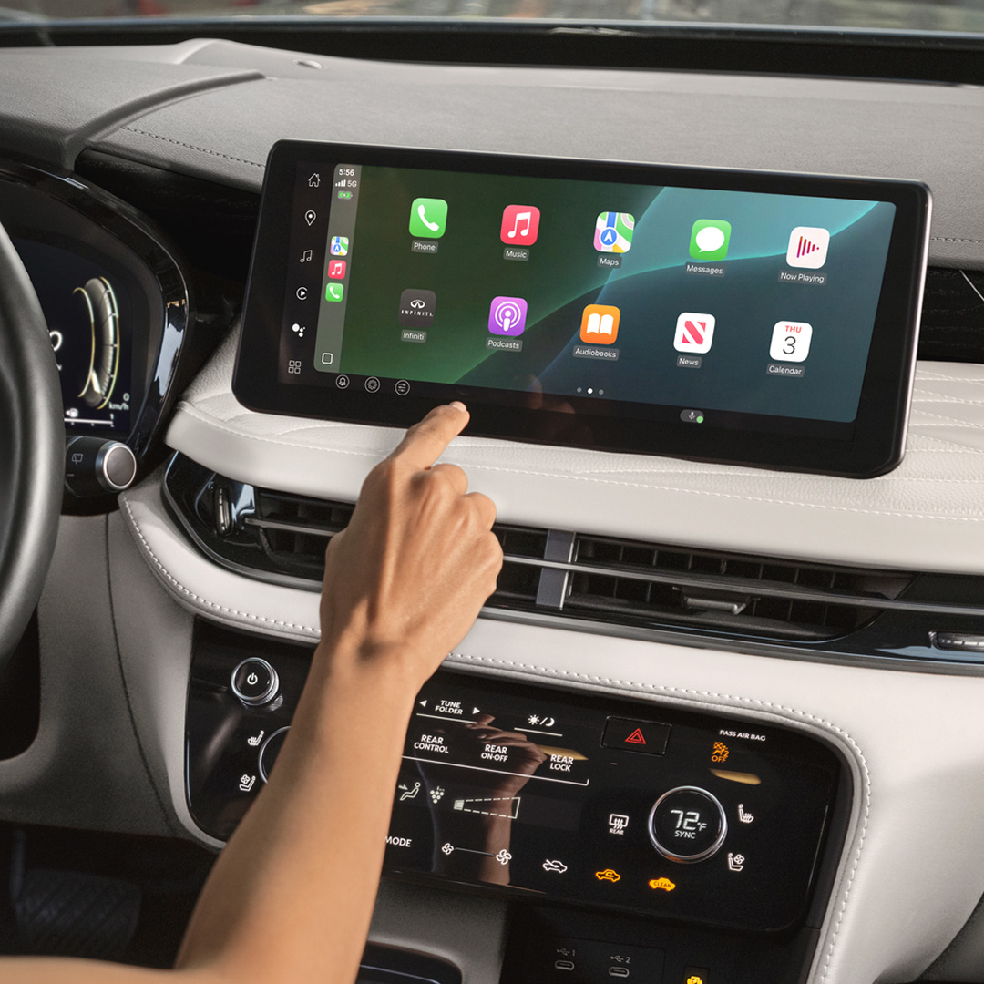 Driver using voice-activated calendar on InTouch with Apple CarPlay display active
