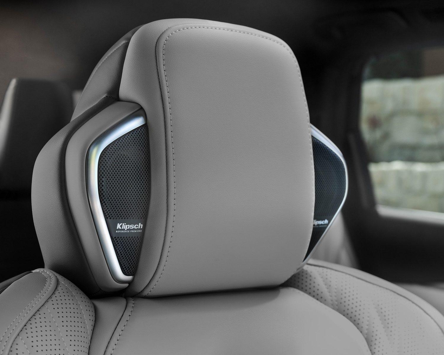 Rear headrest speaker with ambient lighting on light leather trim