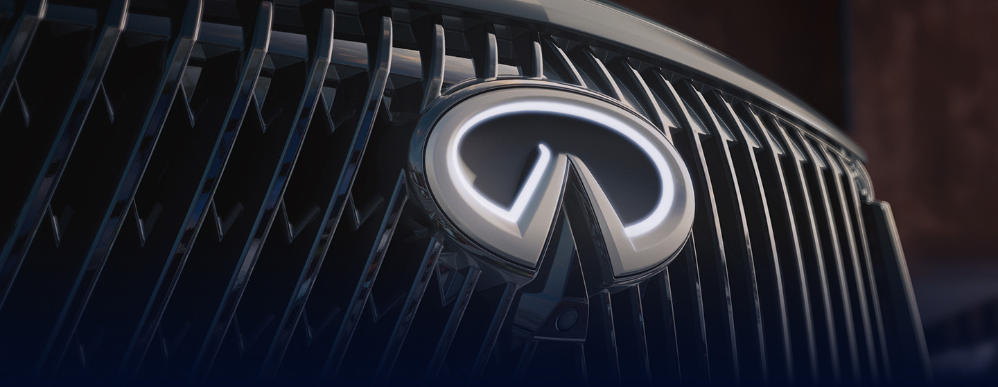 INFINITI QX60 grille in close-up with dark background