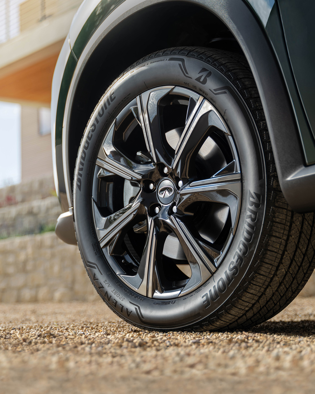 Close-up of 2026 INFINITI QX60 gloss black 20-inch alloy wheel with Bridgestone tire