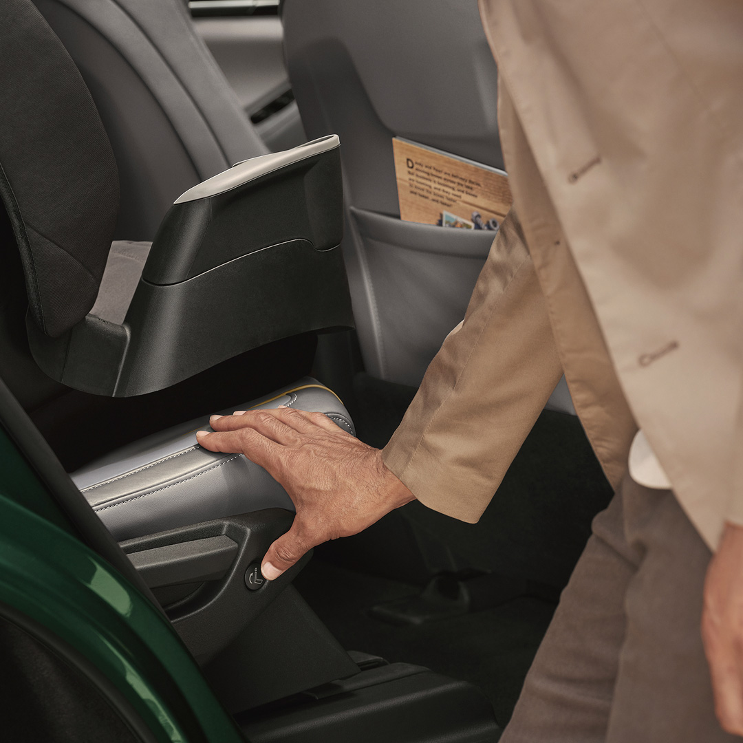 Hand operating one-touch access to the third row in 2026 QX60 interior