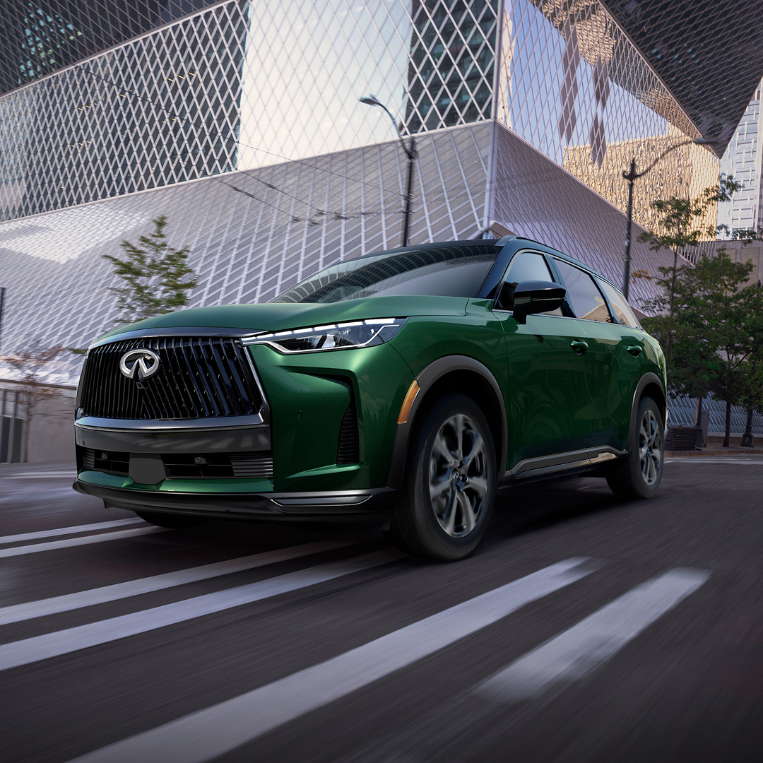 Front angle of the 2026 INFINITI QX60 in motion, showcasing VC-Turbo engine and grille