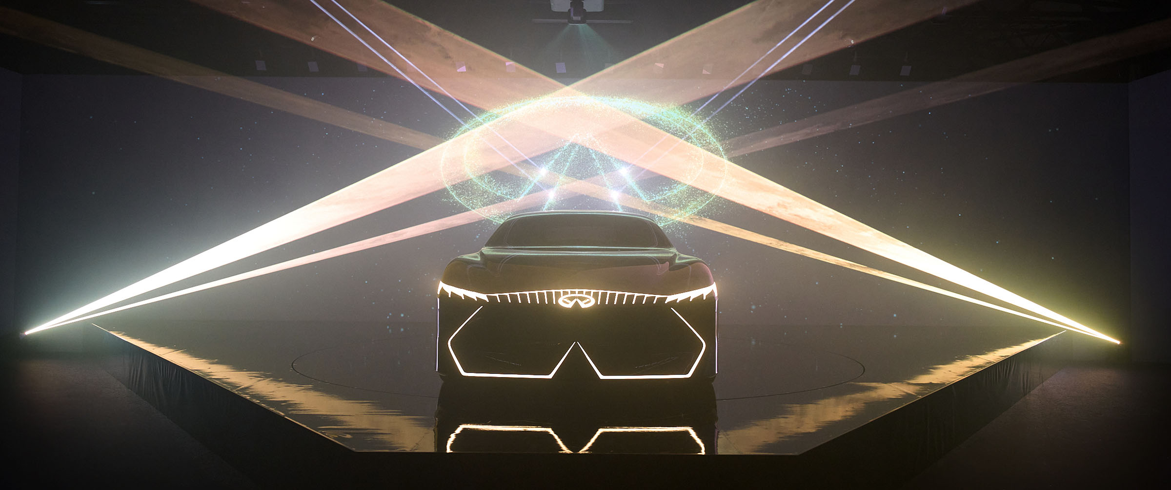 The INFINITI Vision Qe electric car being revealed in front of a starry background