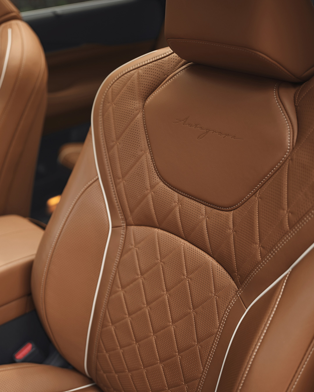 Luxurious quilted leather seat in an INFINITI car, showcasing premium design and attention to detail.