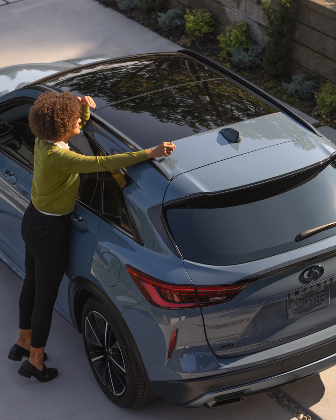 Person interacting with the roof of an INFINITI car, representing updates on brand news and events.