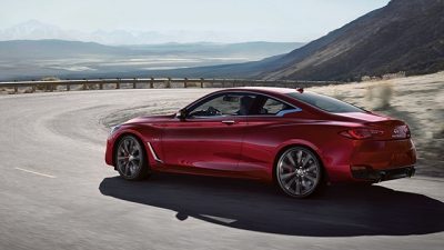 INFINITI car in red turning the corner on a cliff