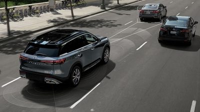 Overhead view of an INFINITI SUV driving on the road with two other cars