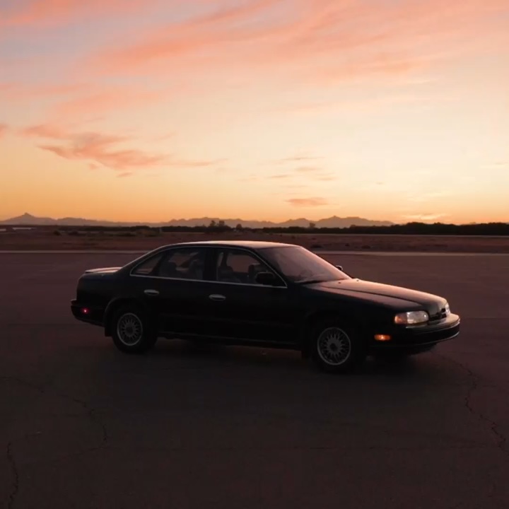 INFINITI Q45 sedan parked in front of sunset