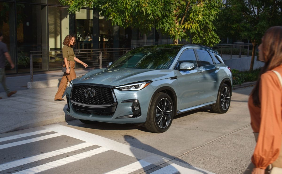 Owner walking towards INFINITI QX50 compact SUV