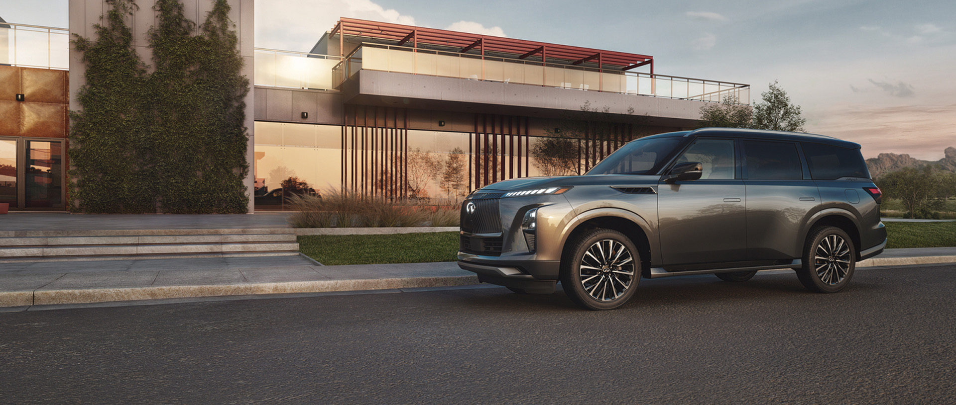 Side view of INFINITI QX80 parked in front of house