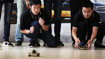 INFINITI Engineering Academy participants racing miniature models