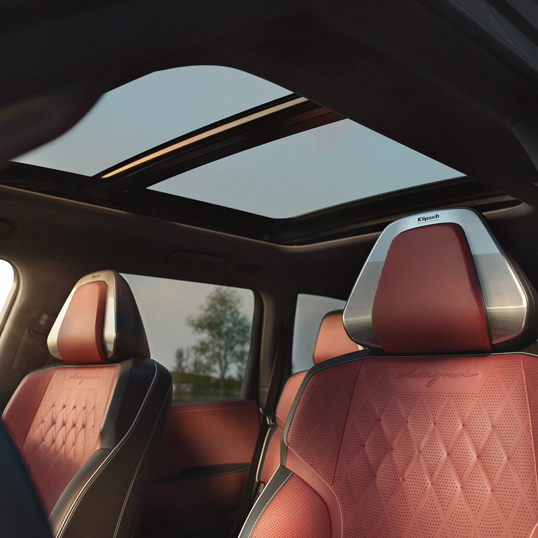 Interior of an INFINITI car with premium seats and a panoramic sunroof, emphasizing accurate sound performance