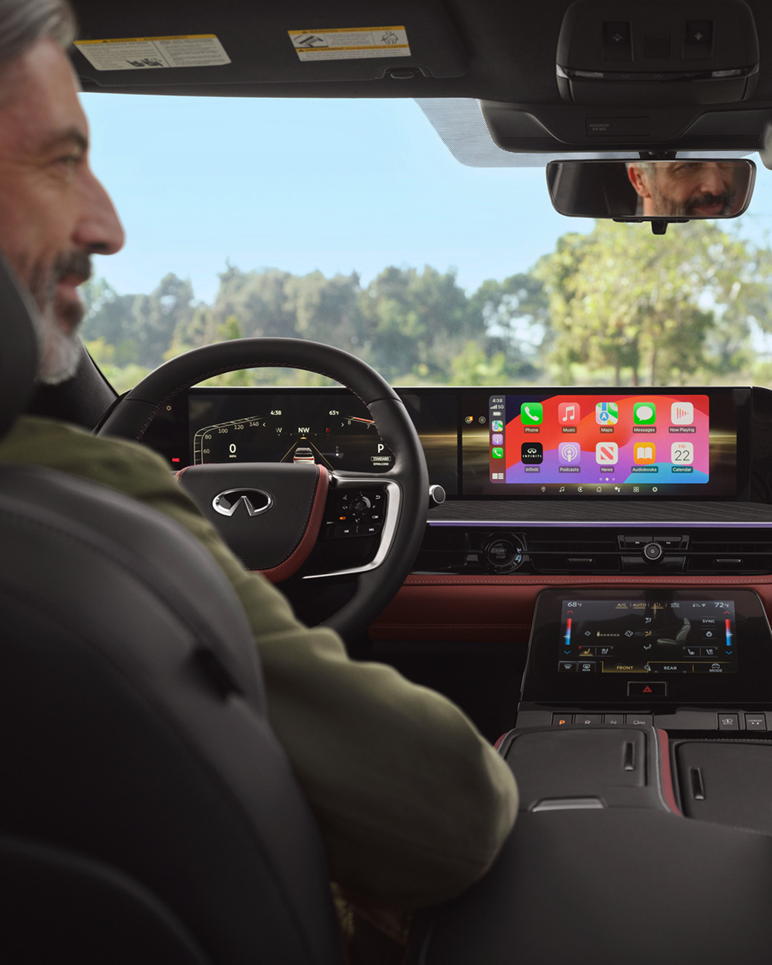 Driver in an INFINITI car using voice commands for hands-free calls, enhancing safety and convenience