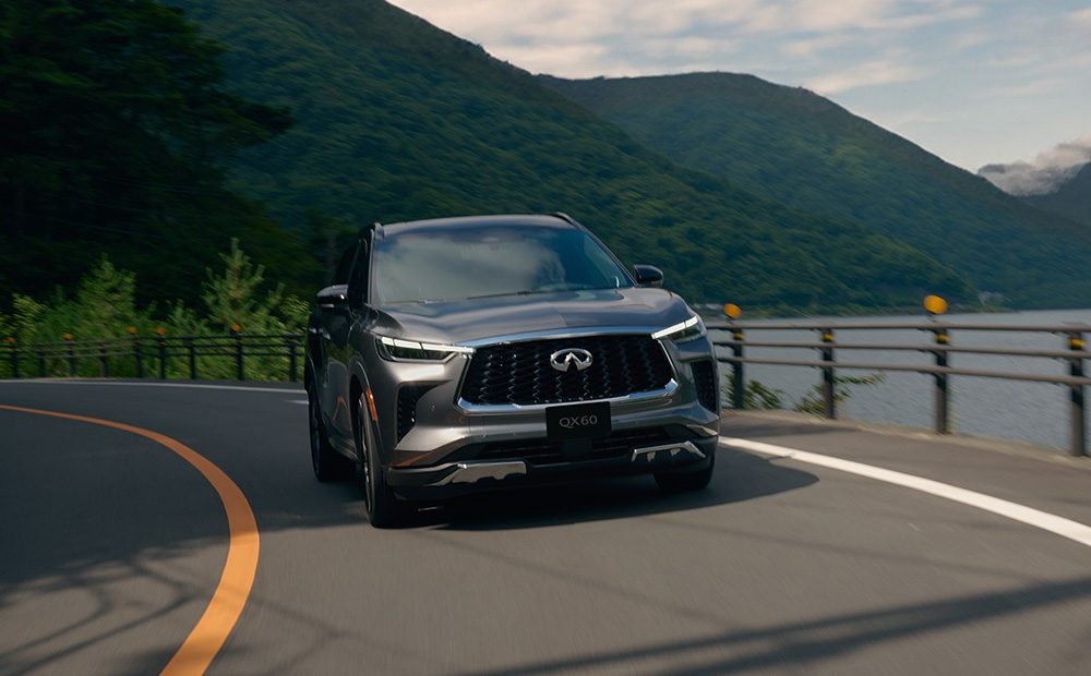 INFINITI QX60 utilizing Intelligent All-Wheel Drive on a winding road, ensuring traction and control