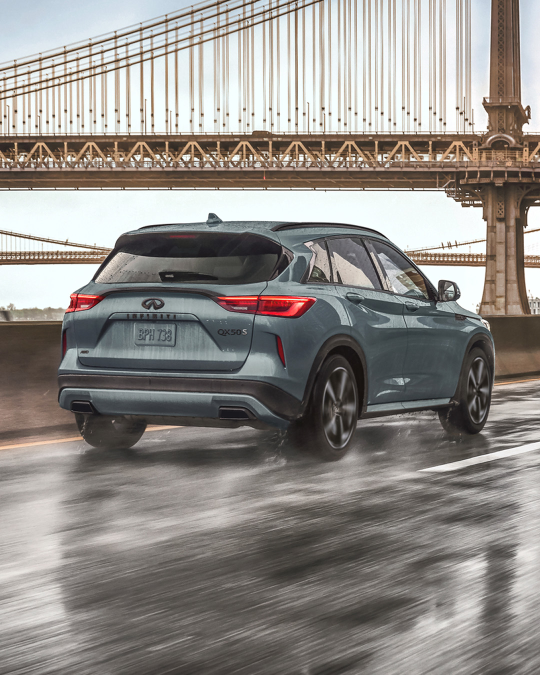 INFINITI QX50 with a VC engine providing 268 horsepower, driving near a bridge