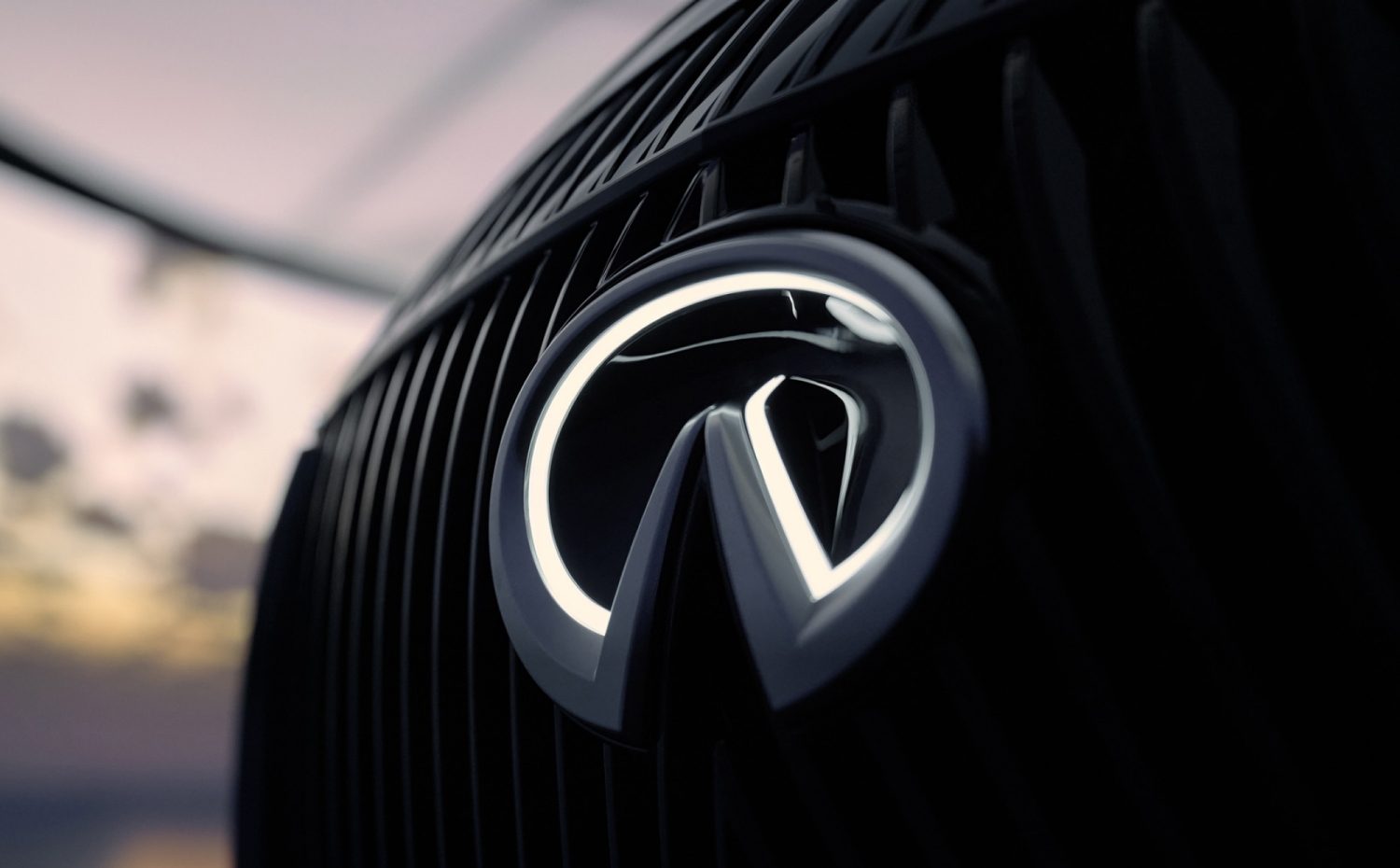 Closeup of INFINITI car logo badge