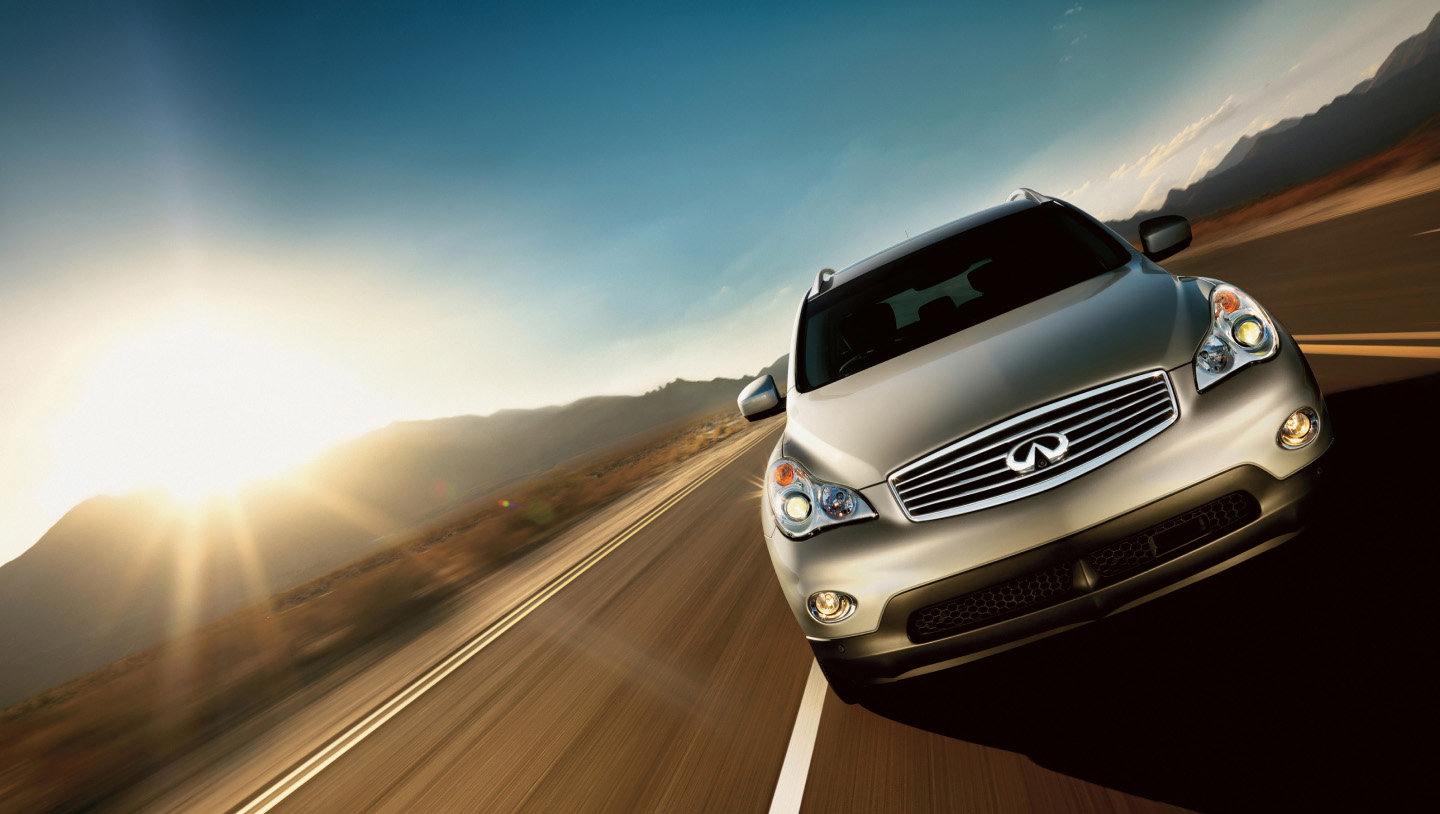 Front view of a silver grey INFINITI EX35 compact luxury SUV driving fast