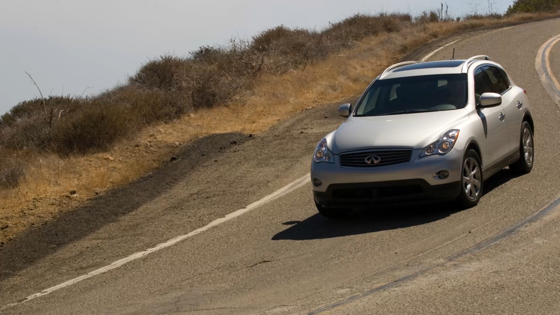 INFINITI EX35 Luxury compact SUV driving down a hill