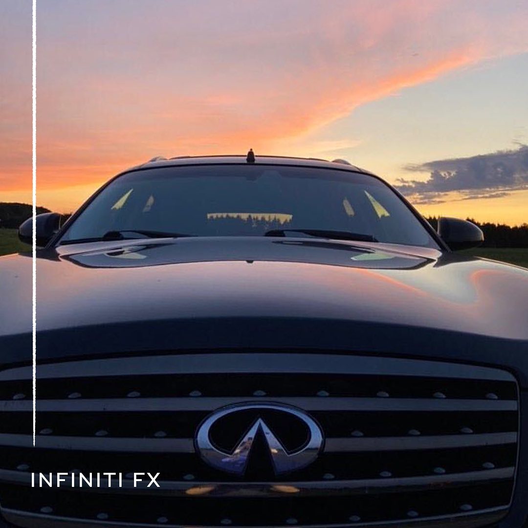 Front view of INFINITI FX35 luxury crossover coupe parked in front of sunset
