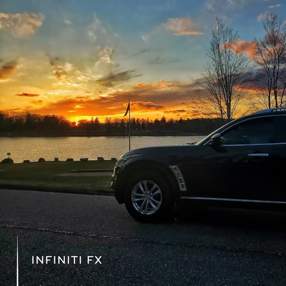 Front end of INFINITI FX35 luxury crossover coupe parked in front of sunset