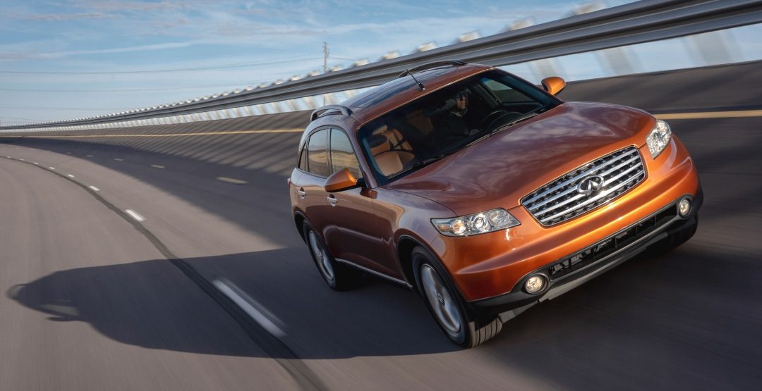 INFINITI FX35 luxury crossover coupe in orange driving on racetrack