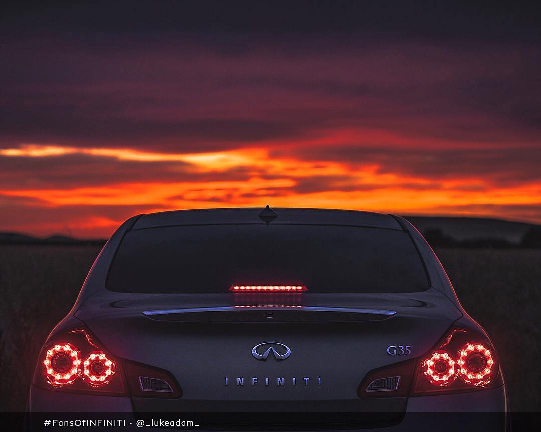 Rear view of INFINITI G35 luxury sport coupe parked in front of sunset