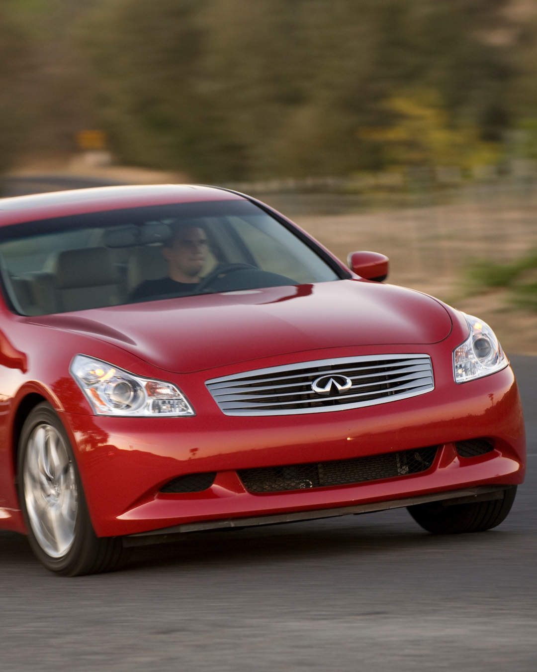 INFINITI G37 luxury sport sedan in red demonstrating 3.7L V6 engine