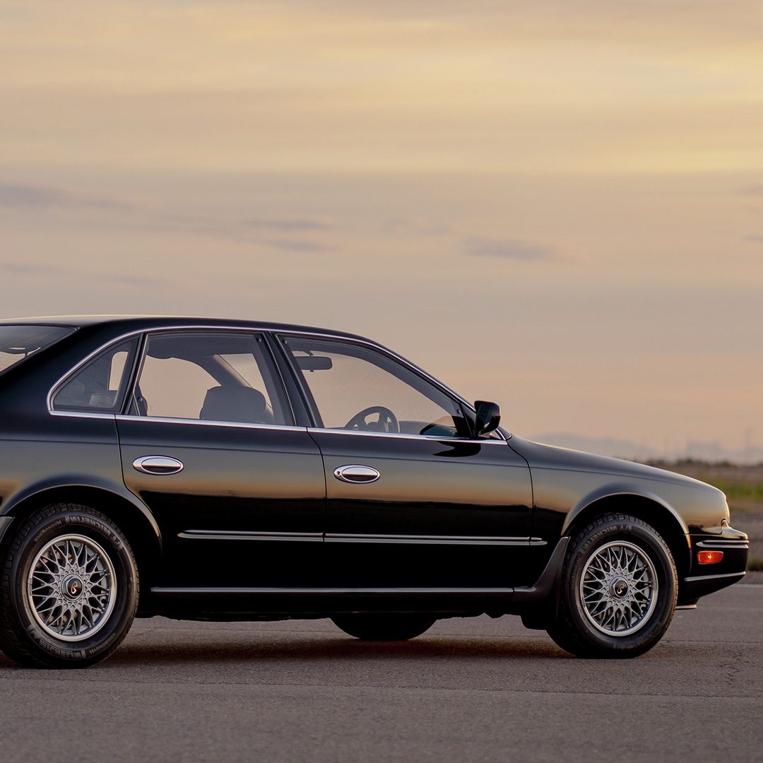 A black 1989 INFINITI Q45 sedan at sunset